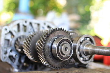 Gears or car parts being lifted out for repair.