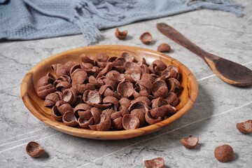 Chocolate cereal on the wooden plate