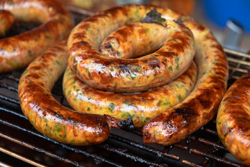 Northern Thai sausage is made with aromatic lemongrass, kaffir lime peel and leaves, spicy red chilies, galangal and turmeric, layered and grilled on a griddle.