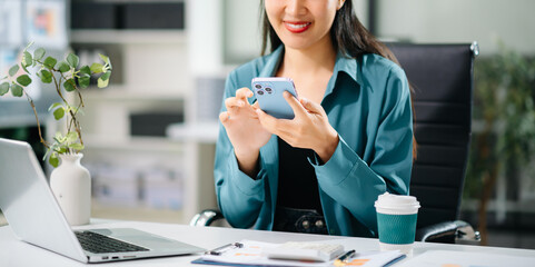 Woman hand using smart phone, tablet payments and holding credit card online shopping, omni channel, digital tablet docking keyboard computer at office