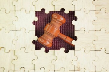 Wooden puzzle and judge's gavel in the middle. concept of justice and judiciary. The concept of the...
