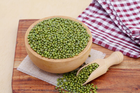 Whole green moong dal or mung beans or green gram (Vigna radiata) green legumes in wooden bowl
