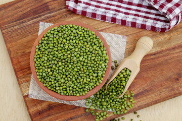 Whole green moong dal or mung beans or green gram (Vigna radiata) green legumes in clay bowl
