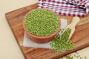 Whole green moong dal or mung beans or green gram (Vigna radiata) green legumes in clay bowl