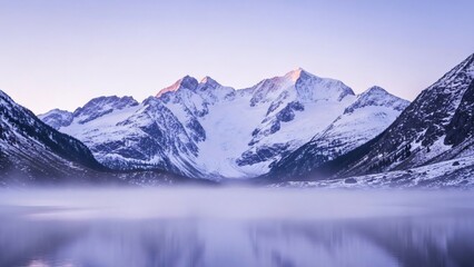 Alpenglow on snowy mountain peaks reflecting in a misty lake at dawn.