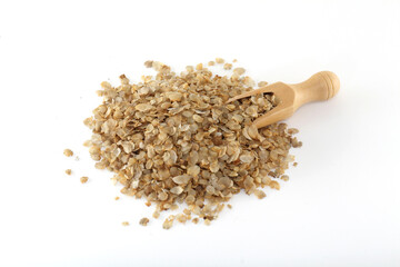 Pearl millet flakes spilled out of scoop