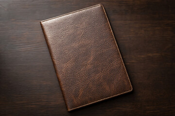Elegant brown embossed leather journal or notebook on dark wooden surface