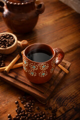 Cafe de Olla, traditional black Mexican coffee, spiced with cinnamon and piloncillo, prepared in a pot and served in a handmade clay cup called a jarrito.