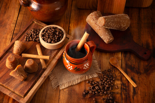 Cafe de Olla, traditional black Mexican coffee, spiced with cinnamon and piloncillo, prepared in a pot and served in a handmade clay cup called a jarrito.
