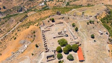 Bergama, Turkey. Summit of the acropolis with the Trajaneum temple and Altar of Zeus on windy hot...