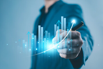A business hand drawing a glowing rising graph with digital bars and arrows, symbolizing financial growth, data analytics, success, performance improvement, and modern business strategy in a digital