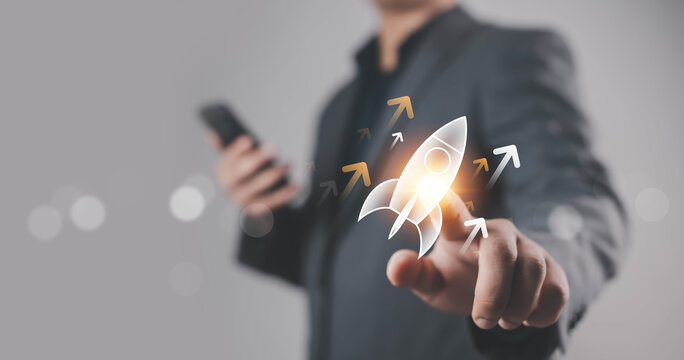 A business hand launching a glowing rocket icon, symbolizing startup growth, innovation, leadership, success, and forward progress, representing modern business strategy and digital transformation