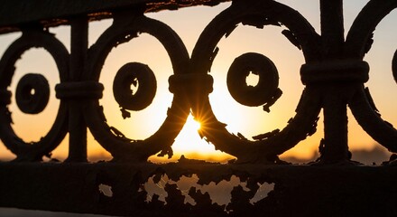 Ornate Ironwork Silhouette Against a Vibrant Sunset Sky.