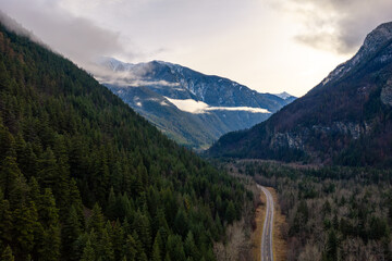 Winding Mountain Road Through Dense Forest Valley in British Columbia, Canada