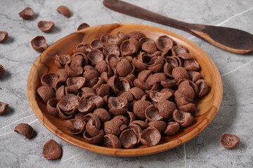 Chocolate cereal on the wooden plate