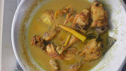 Chicken pieces cooked in rich yellow spiced broth