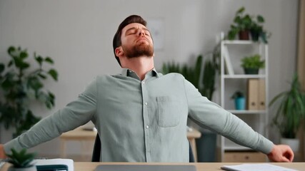 A mindful businessman taking a well-deserved stretch break at his desk, leaning back in his chair to relieve office fatigue and stress