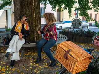 Women friends enjoying conversation in autumn park