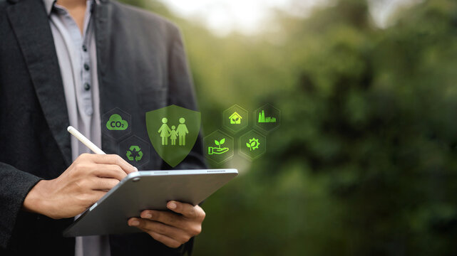 Businessman Using Tablet with Sustainability and Insurance Icons