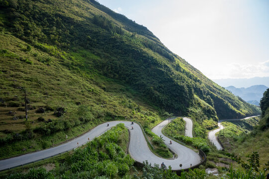 Motorcyclists Riding up Winding Road on Tham Ma Pass, Ha Giang Loop, Vietnam