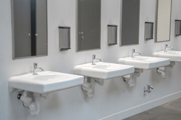 sinks in a row in public bathroom