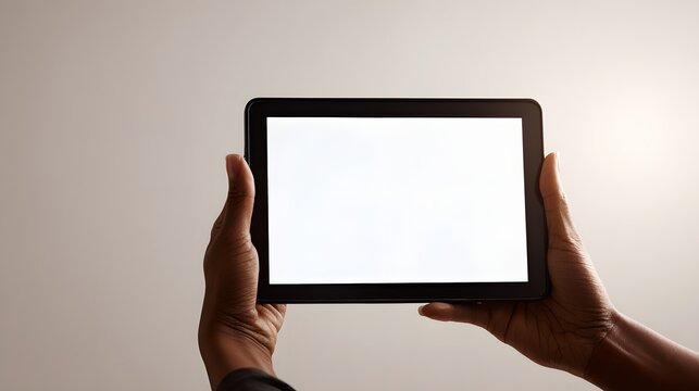 Hands holding a tablet with a blank white screen, ready for custom content display.