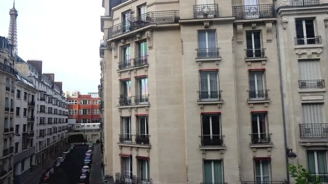 Wide and Cinematic view of Parisian buildings from the subway window.