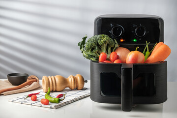Fresh Vegetables in Air Fryer Basket with copy space.