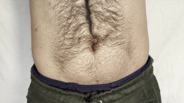 fat man breathing in and out and showing his fat belly, obese man. Man showing his belly fat signs of obesity.