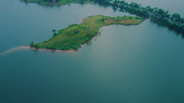 Aerial drone view of Banswara lakes and islands near Udaipur, Rajasthan, India, captured during a breathtaking sunrise, showcasing a cinematic blend of natural beauty with a boat moving across the wat