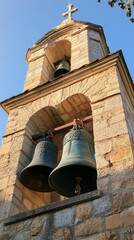 Obraz premium Church bell tower with cross reaching blue sky