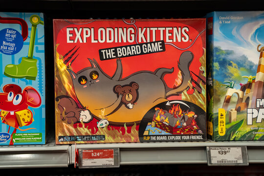 View of Exploding Kittens board game displayed on store shelf. Toronto, Canada - November 26, 2025.