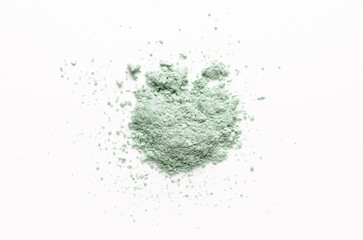 A sample of dry cosmetic clay for a skin mask. White background