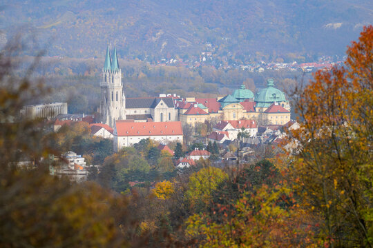Klosterneuburg Abbey architecture seen through autumn forest foliage with colorful leaves in Austria