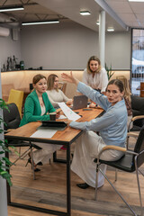 Business meeting presentation: Team of women discussing strategy and analyzing charts in modern office