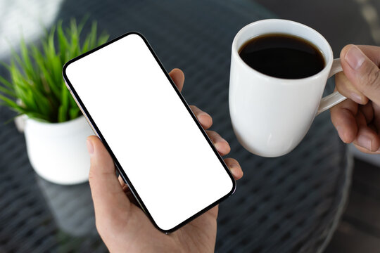 Male hands holding  phone isolated screen and cup of coffee