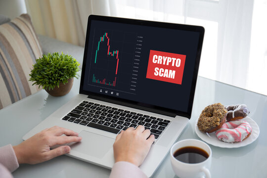 female hands laptop keyboard with chart scam crypto coins screen