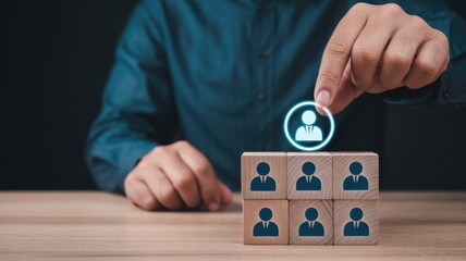 Manager selects an ideal employee from a group represented by wooden blocks