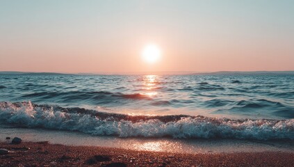 Obraz premium Sunset over a tranquil beach. Soft light paints the sea and waves