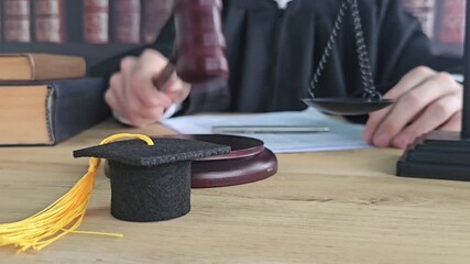 Graduation ceremony celebration with gavel, scales, and law books at a legal profession setting