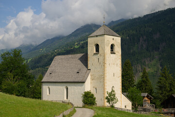 Fototapeta premium Saint Nikolaus church Bichl Matrei in Osttirol Austria sunny summer day meadow landscape