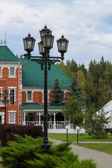 A lamppost and old-style lanterns near a street cafe in the city