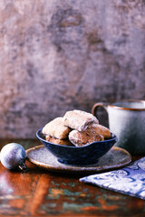 Traditional christmas cookies in a bowl on a rustic wooden background. Soft focus.	