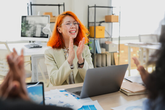 Diverse business professionals, both male and female, collaborate in a bright modern office, using an AI-powered virtual assistant to brainstorm innovative ideas, analyze big data insights	