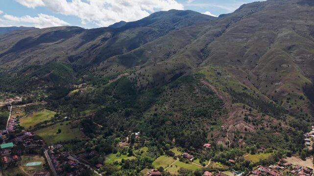 Drone flying towards the plaza mayor, the main square of villa de leyva, a historic colonial town. tilt down movement