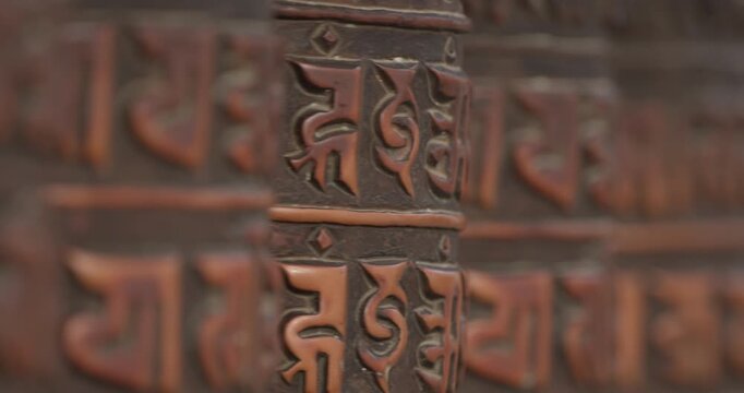 Prayer wheels spin gently at Boudhanath Stupa as soft &ldquo;Om Mani Padme Hum&rdquo; chants fill the air, creating a quiet spiritual moment in the heart of Kathmandu&rsquo;s sacred Buddhist sanctuary