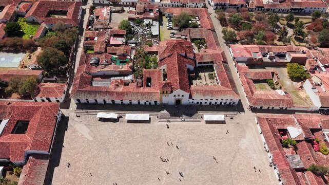 Drone flying backwards revealing the historic colonial town and main square of villa de leyva, boyaca