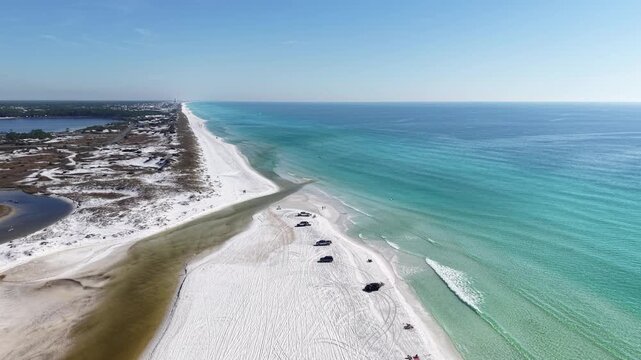 Drone orbit of a long white sandy beach curving along turquoise Gulf coastal waters, 30A, Florida, USA