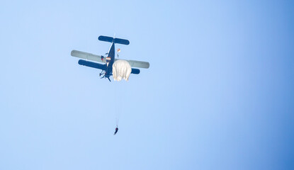 Skydiving. Parachutists jump from a flying plane in the air. Extreme sport and entertainment.