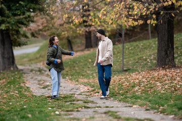 Fototapeta premium Mature couple enjoying autumn park walk laughing together